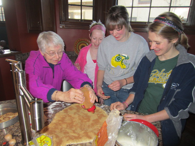 Avrie, MacKenzie and Morgan sprinkling cinnamon with Grandma Cuckoo